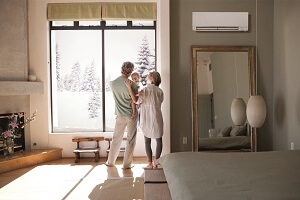 ductless heating unit installed in a home family looking out a window