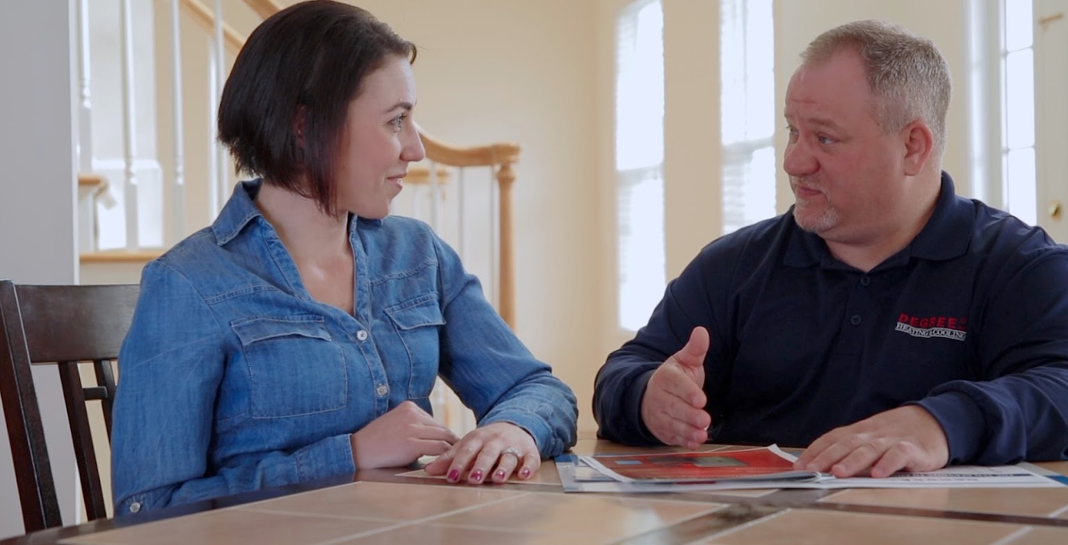 Degree technician talking to a woman at a table