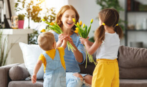 children surprise mom with tulip bouquet