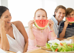family enjoying summer feast in cool comfortable home